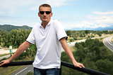 Handsome blond man on scenic highway background in France