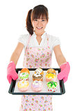 Young Asian female baking bread and cupcakes
