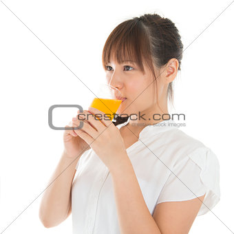 Asian woman drinking orange
