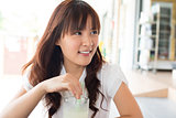 Young Asian woman enjoying drinks