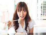 Asian girl eating dim sum