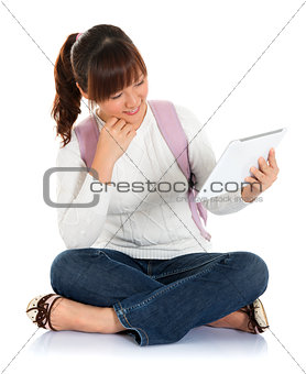 Asian female student using tablet pc