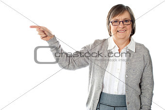 Portrait of beautiful aged woman pointing