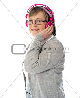 Aged woman enjoying music