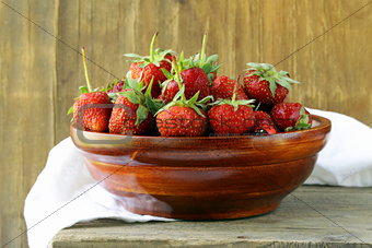 wooden bowl with ripe fresh strawberries