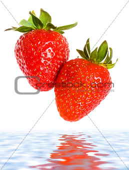 fresh ripe strawberries falling in water