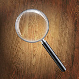 Wooden Background With Magnifying Glass