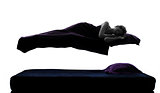  woman sleeping in levitation on bed silhouette