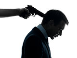 business man with gun pointing to his head  silhouette