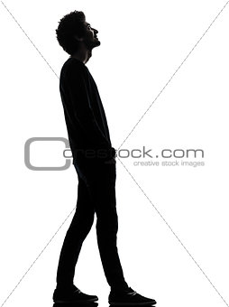handsome african young man standing looking up smiling silhouett