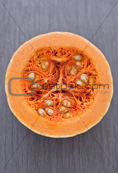 Orange cut pumpkin on a wooden table