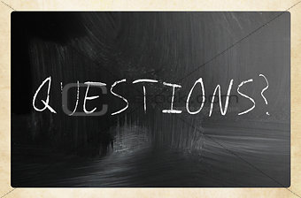 "questions" handwritten with white chalk on a blackboard