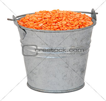 Red lentils in a miniature metal bucket