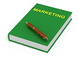 Green book on marketing and brown pen 