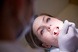 Young woman in dental clinic with dentist checking teeth hygiene