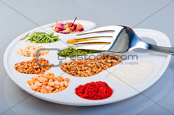 The palette of spices and groceries with a fork