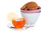 Glass cup of black tea with lemon and cookies