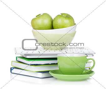 Ripe green apples, coffee cup and office supplies