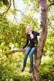 Girl sitting on a apple tree  