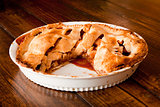 Freshly baked apple pie with a missing portion 