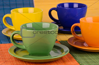 A set of colorful cups with plates