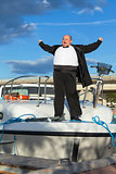 Fat man in tuxedo on deck boat