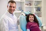 Portrait of child and dentist in dental studio, looking at camer
