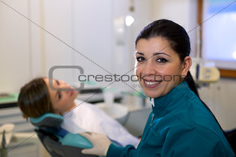 Portrait of woman and dentist in dental studio, looking at camer