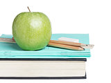 school supplies with apple on book