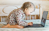 little girl is sitting at the computer