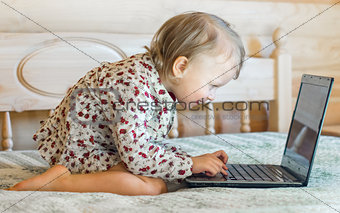 little girl is sitting at the computer