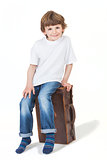 Young Happy Boy Smiling Sitting on Suitcase