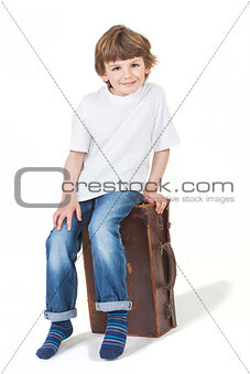 Young Happy Boy Smiling Sitting on Suitcase