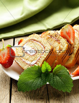roulade cake with cream and fresh strawberries