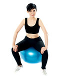 Young athlete sitting on a swiss ball