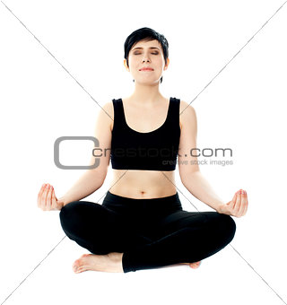 Youung woman meditating in lotus pose