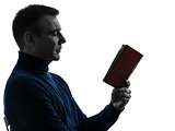 man reading book silhouette portrait