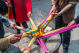 asian people burning incense for praying