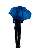 woman rear view holding umbrella silhouette