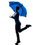 woman happy holding umbrella silhouette