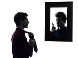 man in front of his mirror dressing up silhouette