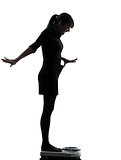 woman standing on weight scale  happy silhouette