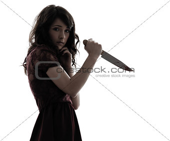 strange young woman killer holding  bloody knife silhouette