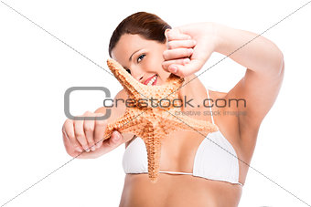 Beautiful woman holding a starfish