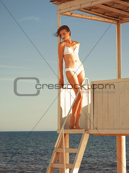 Girl relaxing in a beach gazebo