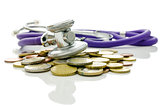 Stethoscope on Euro coins on a white background