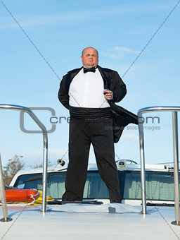 Fat man in tuxedo with glass wine