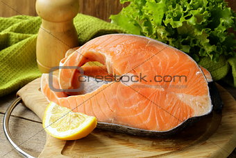 fresh raw red fish (salmon) on a cutting board