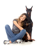 Young woman with black dobermann dog