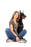 Young woman with black dobermann dog